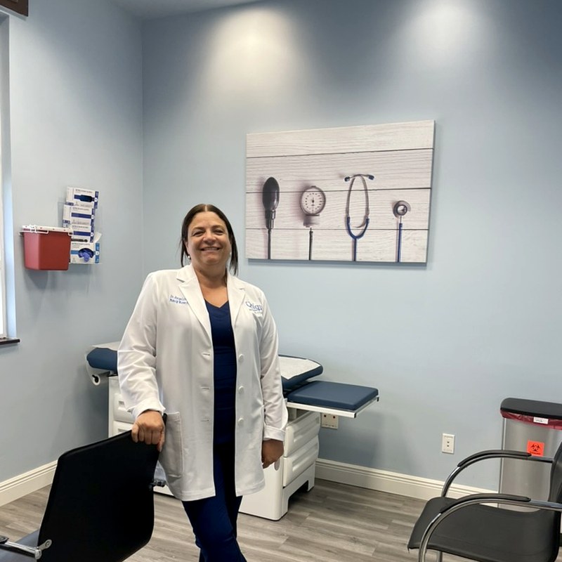 Dr. Valdes standing in her exam room, ready to welcome patients
